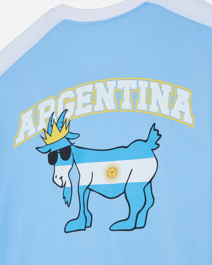 T-shirt with a cartoon goat wearing a crown and sunglasses, featuring the Argentina flag on a light blue background.