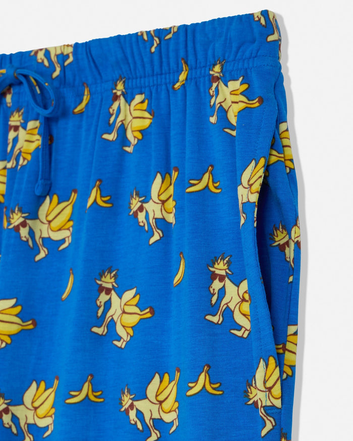 Blue shorts with a cartoon goat and banana pattern on a white background