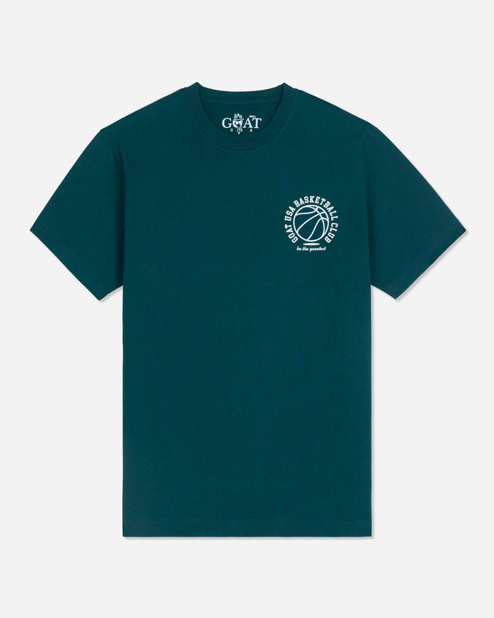 A dark teal green short-sleeve t-shirt with a white circular graphic on the left chest featuring a basketball and the text 'GOAT BASKETBALL'. The inner neck label shows the brand 'GOAT'.