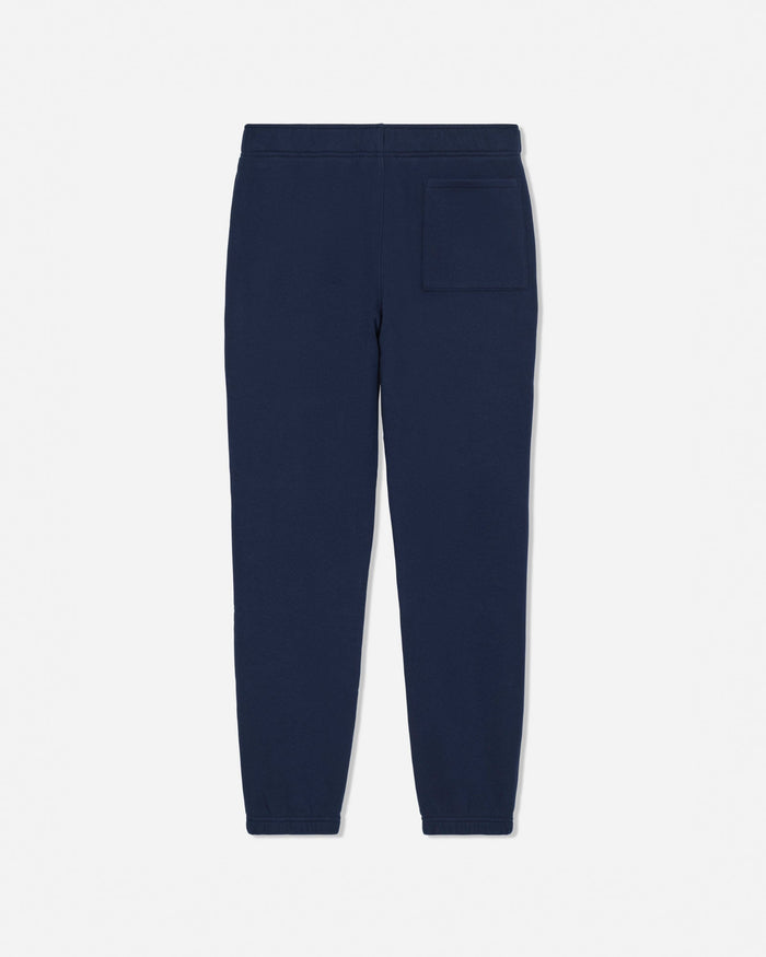 A pair of navy blue sweatpants shown from the back, featuring a flat back waistband and a single patch pocket on the right side, set against a plain light gray background.#color_navy-blazer