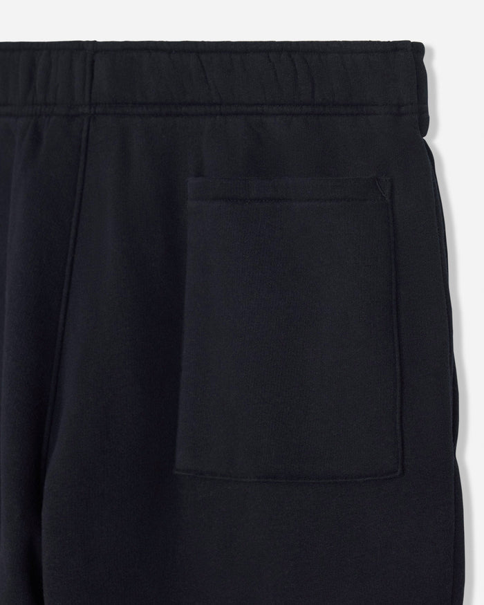 Close-up of black pants with a button on a white background#color_black