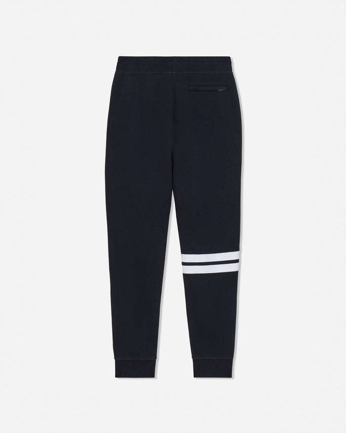 Black jogger sweatpants with double white stripes on the lower leg and a zippered pocket on the back, shown against a light gray background.