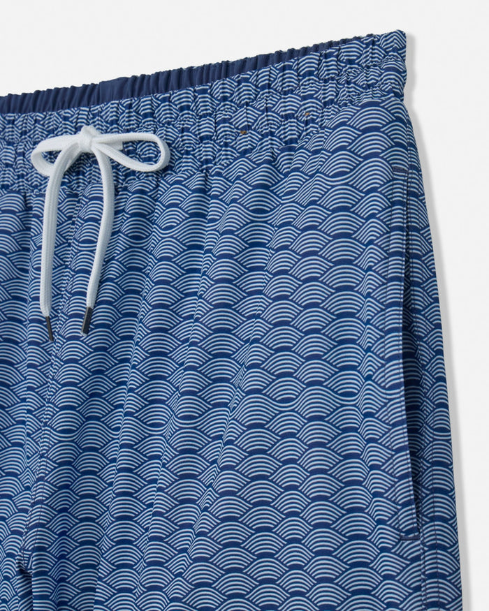 Blue patterned shorts with a white drawstring on a light gray background