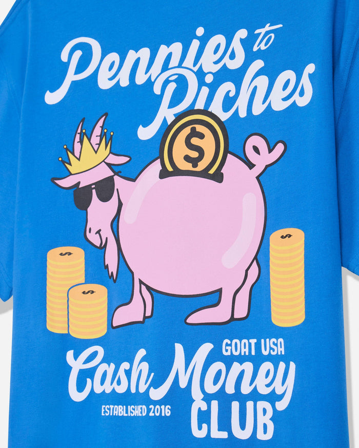 Close-up of royal blue t-shirt with goat piggy bank graphic and 'Pennies to Riches GOAT USA Cash Money Club' text