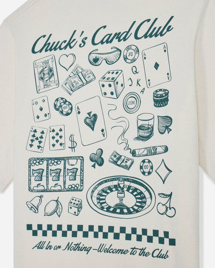 Close-up of bone t-shirt with casino games design and text that reads "Chuck's Card Club All In or Nothing - Welcome to the Club"