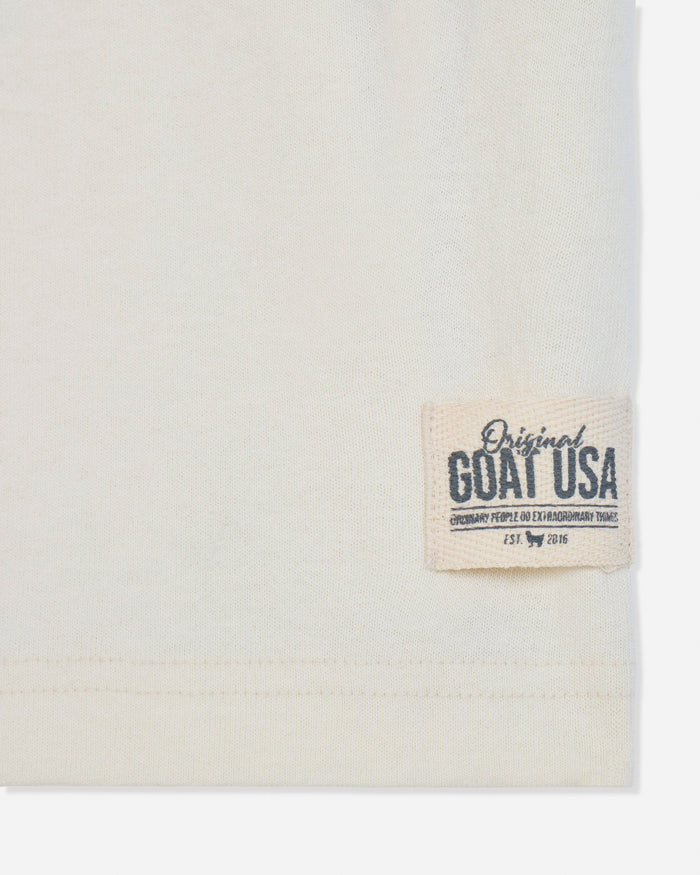 Close-up of stitched patch on bone t-shirt