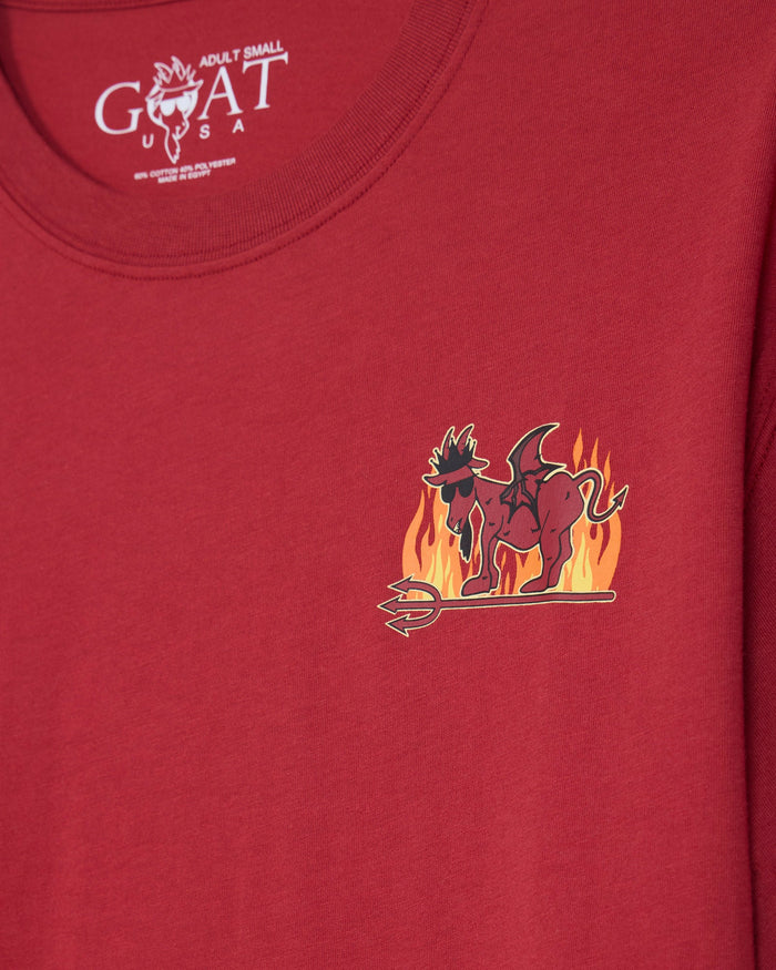 A close-up of a red short-sleeve t-shirt showing the inner neck label with 'GOAT USA' and a small chest graphic of a devil on flames.