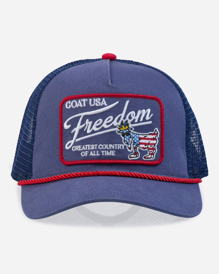 Blue trucker hat with 'Freedom' patch on a white background