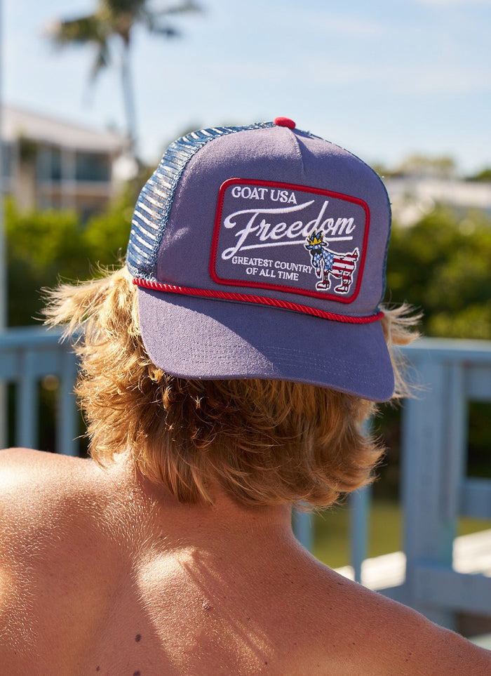 Man wearing a backwards navy and red hat