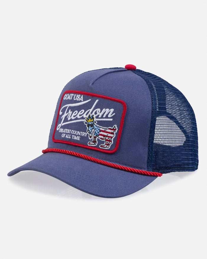 Blue trucker hat with 'Freedom' patch on a white background