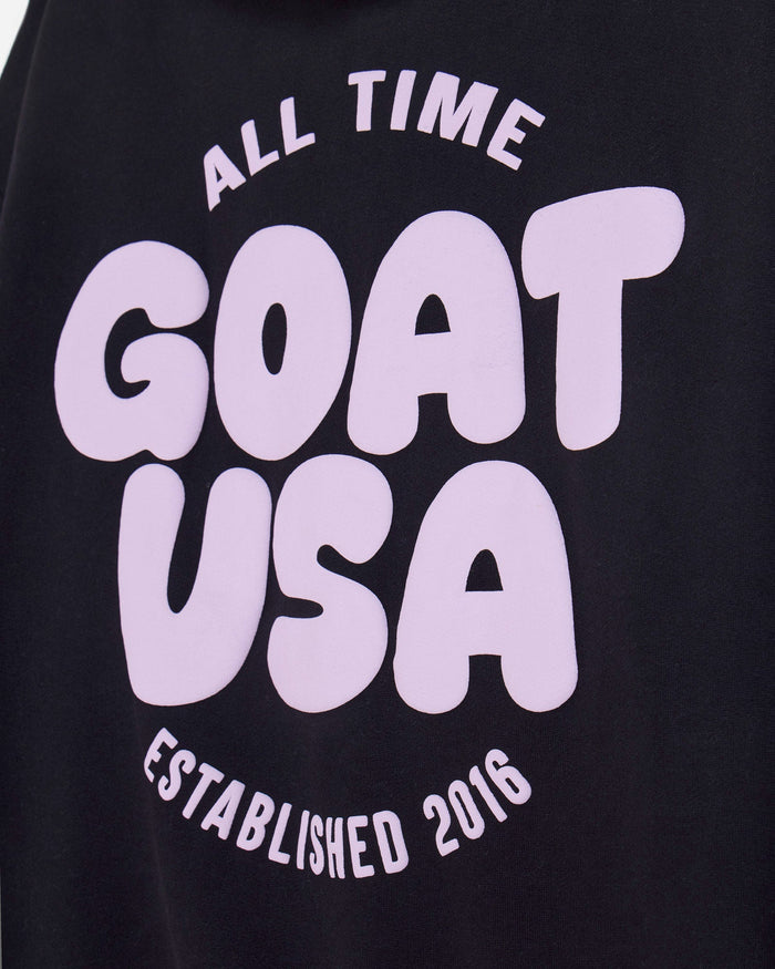 Close-up of back of black hoodie with 'ALL TIME GOAT USA ESTABLISHED 2016' text#color_black