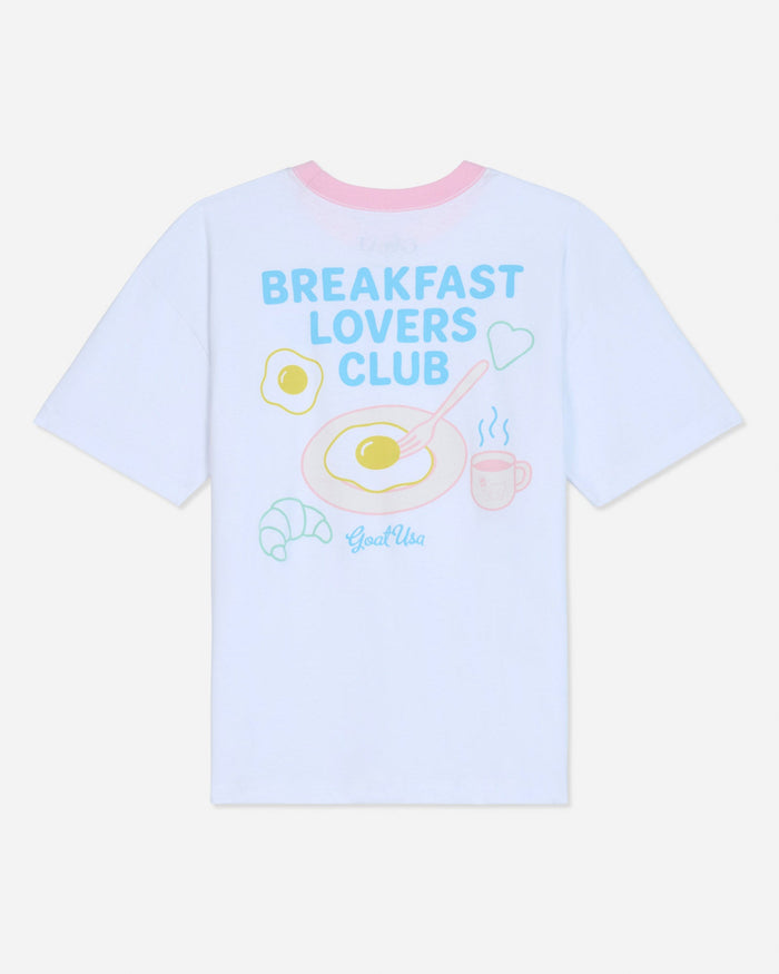White oversized t-shirt that says 'Breakfast Lovers Club' with various breakfast items