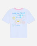 White oversized t-shirt that says 'Breakfast Lovers Club' with various breakfast items