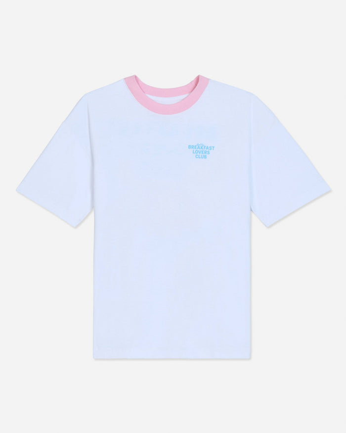White oversized t-shirt with pink collar and blue left-chest graphic