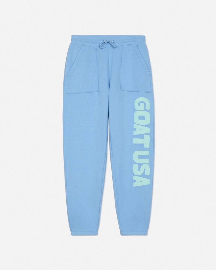 Light blue sweatpants with 'GOAT USA' text on a light gray background#color_carolina-blue