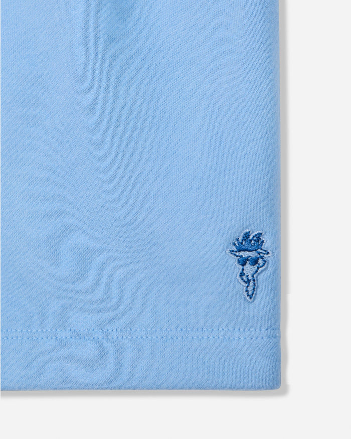 Close-up of carolina blue sweat shorts with goat head patch#color_carolina-blue