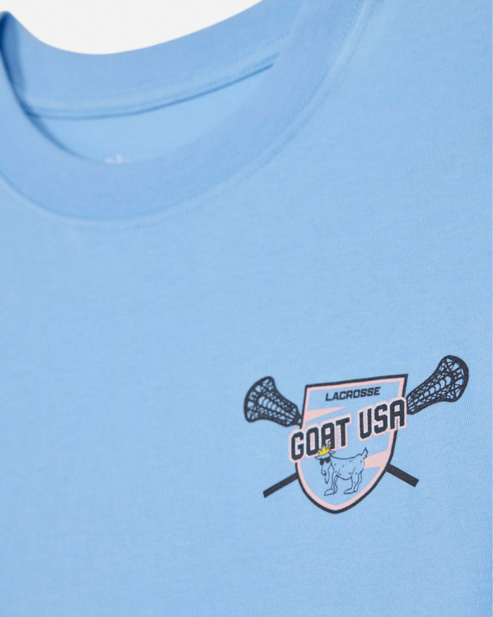 Close-up of blue crop top with lacrosse goat left-chest logo