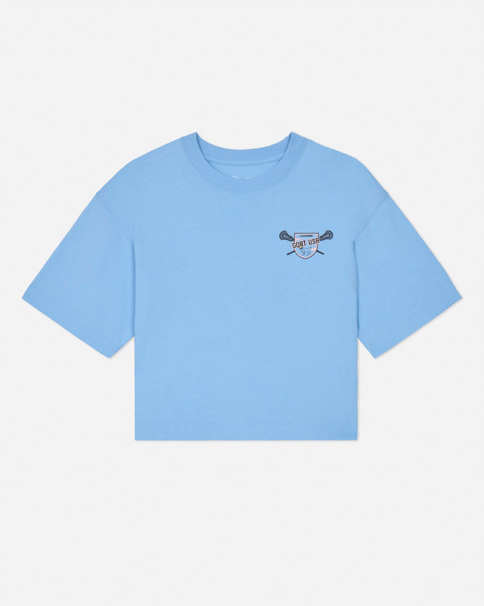 Front of blue crop top with lacrosse goat left-chest logo