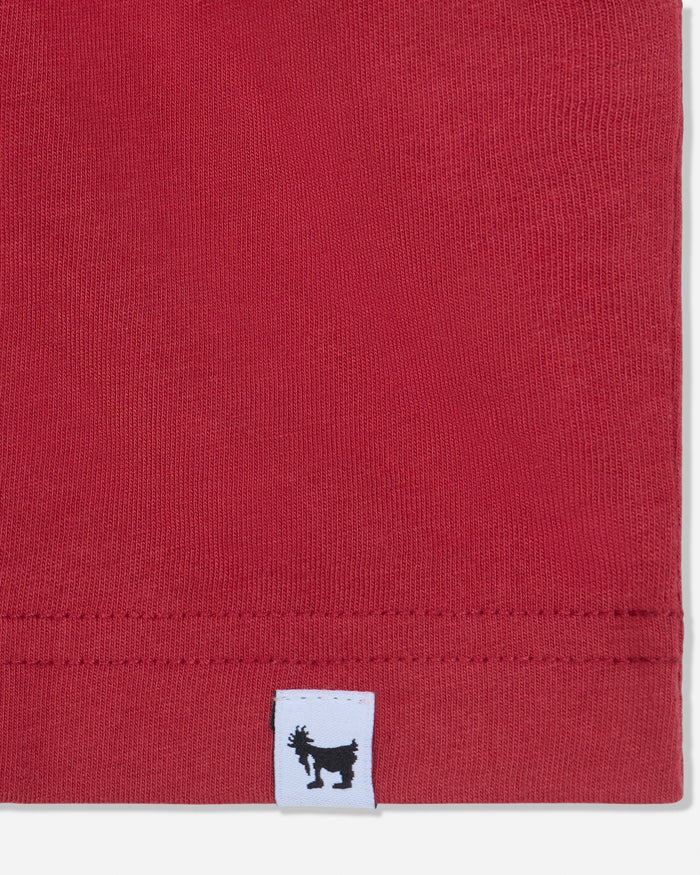 Close-up of stitched tag on red t-shirt