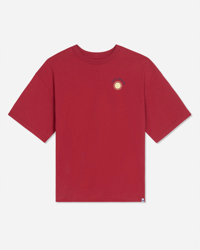 Front of red oversized t-shirt with left-chest graphic