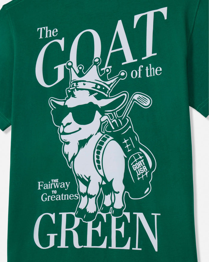 Green t-shirt with white graphic of a goat and golf club, text 'The GOAT of the Green', on a white background.