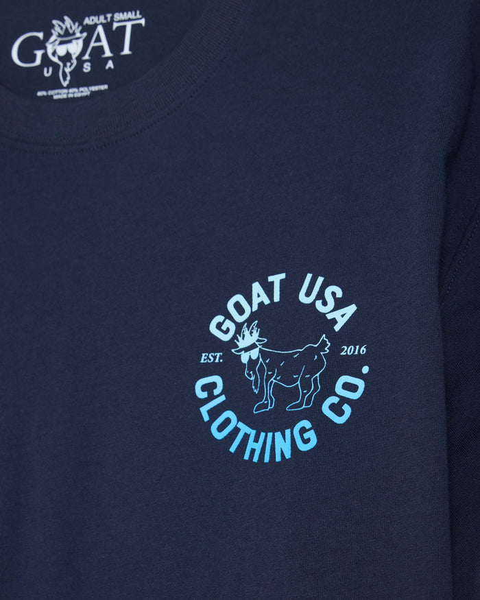 Close-up of a navy blue t-shirt featuring a light blue and white circular 'GOAT USA CLOTHING CO.' graphic on the chest, with the brand's logo printed inside the collar.#color_navy-blazer