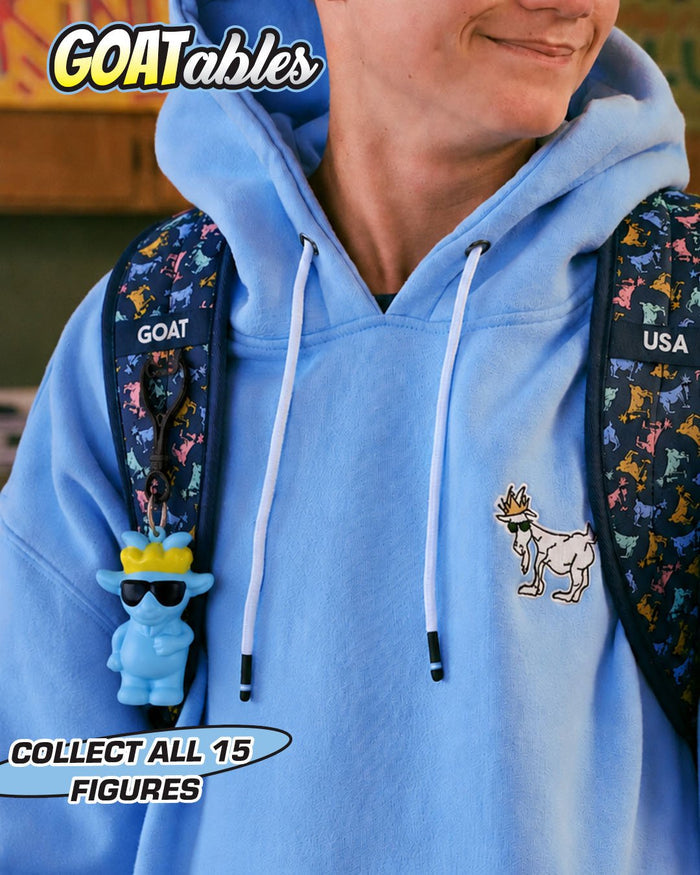 Person wearing a blue hoodie with a goat graphic and a backpack with blue goat keychain featuring 'GOATables' & 'Collect All 15 Figures' text.