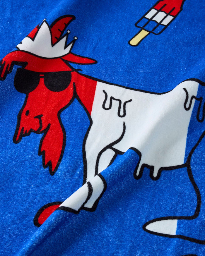 Red, white, and blue popsicle goat on a beach towel