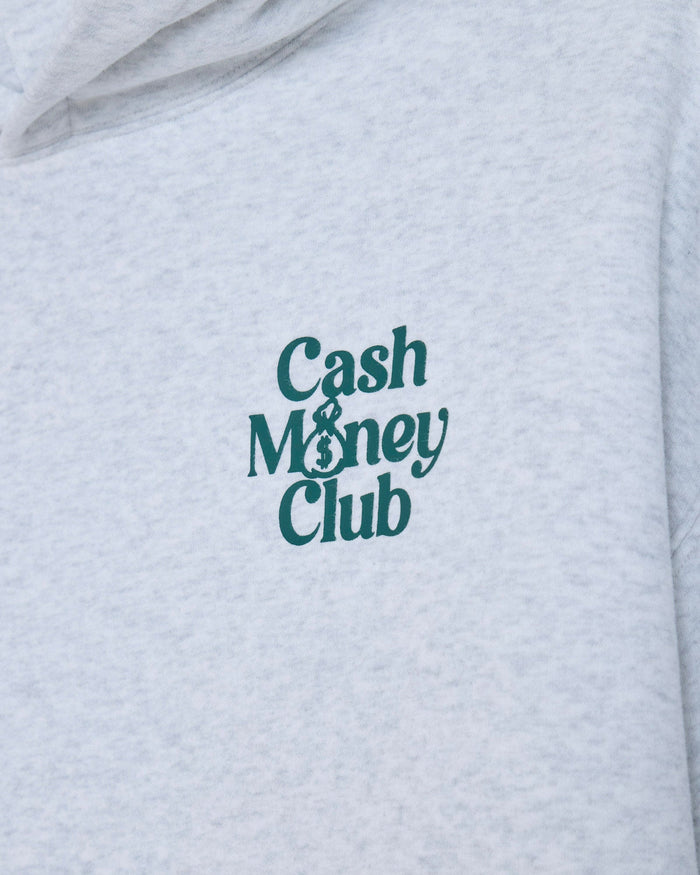 Close-up of a light heather gray hoodie with the words 'Cash Money Club' printed in dark teal on the chest.