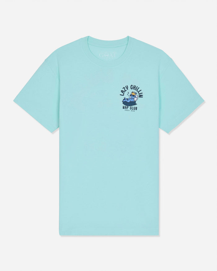 Front of mint t-shirt with goat laying in bed left-chest graphic