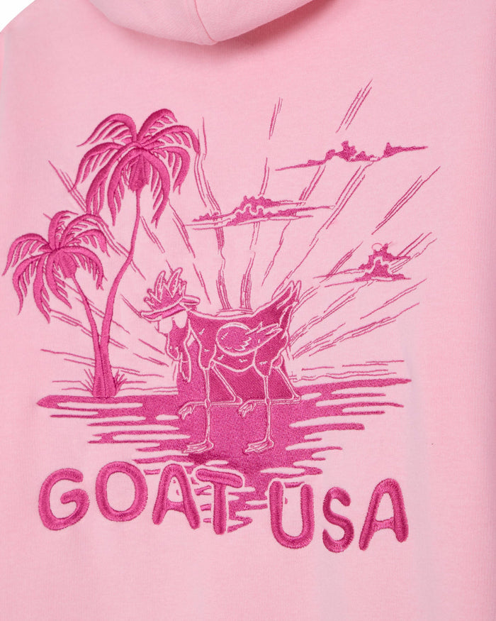 Pink hoodie with a graphic of a goat and palm trees, labeled 'GOAT USA', on a pink background.#color_pink