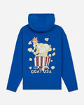 A royal blue hoodie shown from the back, featuring a graphic of a goat wearing a crown sitting in a red-and-white striped popcorn bucket with floating popcorn kernels and the text 'GOAT USA' below.