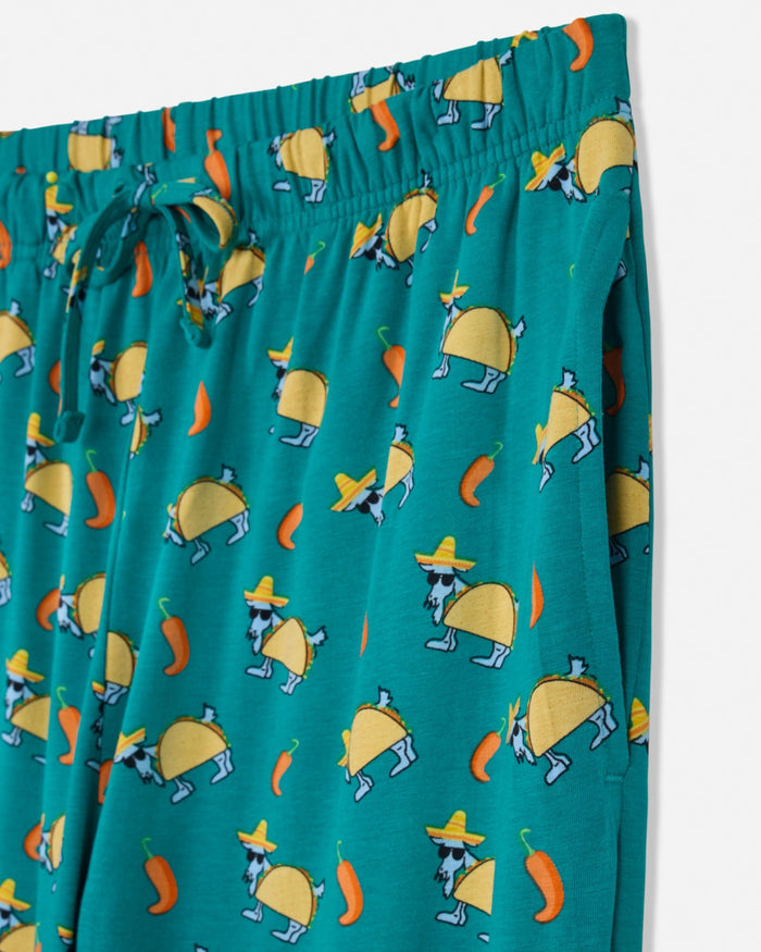 Teal pajama pants with taco pattern on a white background