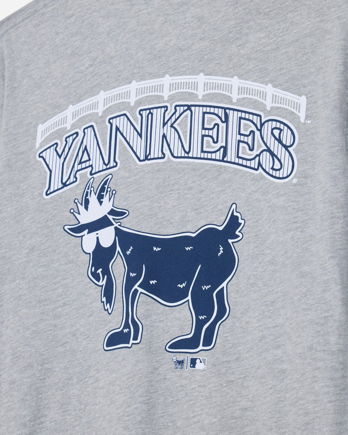 Close-up of a heather gray graphic T-shirt featuring the word 'YANKEES' in arched outlined letters above a navy blue goat logo, with a small MLB logo below.#color_gray