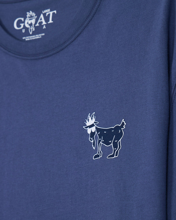 Close-up of a blue t-shirt featuring a small white line-art goat graphic on the chest and a white 'GOAT USA' logo printed inside the collar.#color_navy