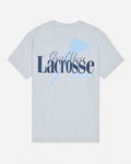A light heather gray short-sleeve t-shirt with a graphic on the front reading 'Goat USA Lacrosse Club' in navy and light blue, featuring a lacrosse stick design.