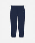 A pair of navy blue sweatpants with an elastic waistband and a small white embroidered logo on the left hip, shown against a light gray background.#color_navy-blazer