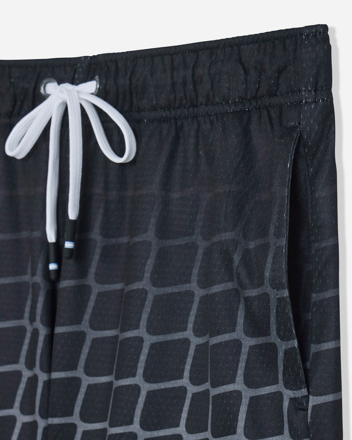 Close-up of pocket on black mesh shorts with a hockey net pattern