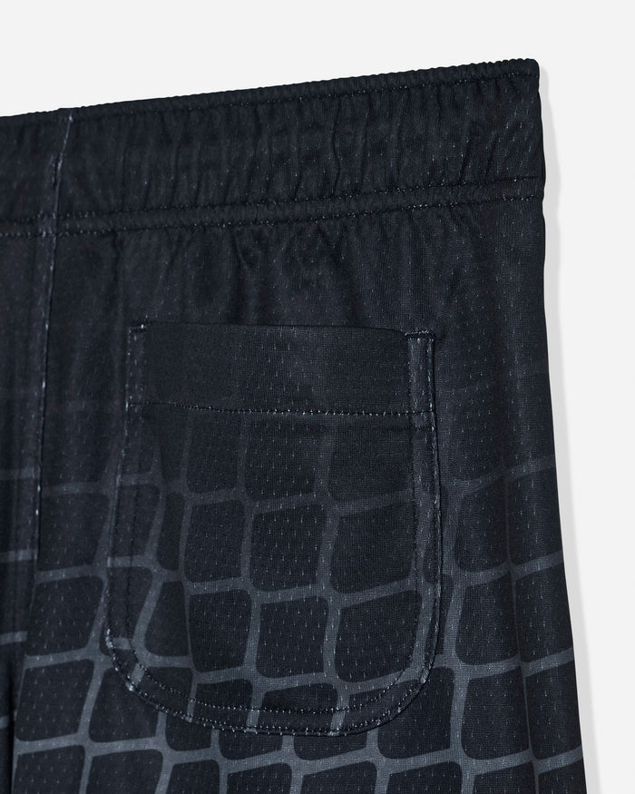 Close-up of back pocket on black mesh shorts with a hockey net pattern
