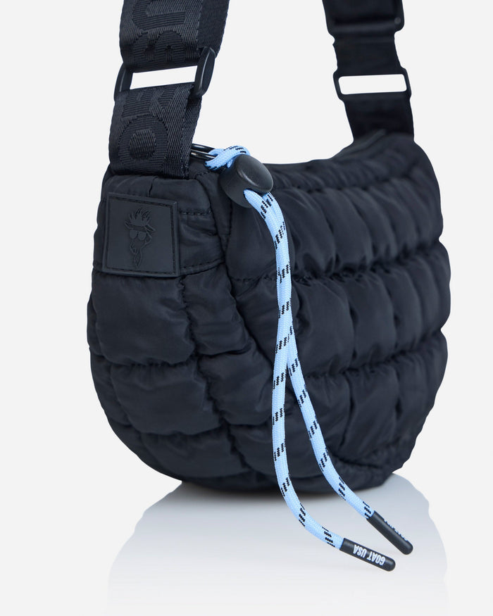 Close-up of strings on black sling bag