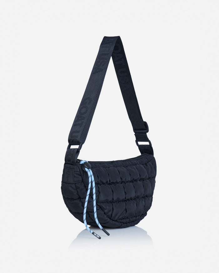 Angled view of black sling bag