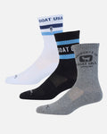 Three pairs of Goat USA crew socks in white, black, and heather gray, arranged diagonally against a light gray background.
