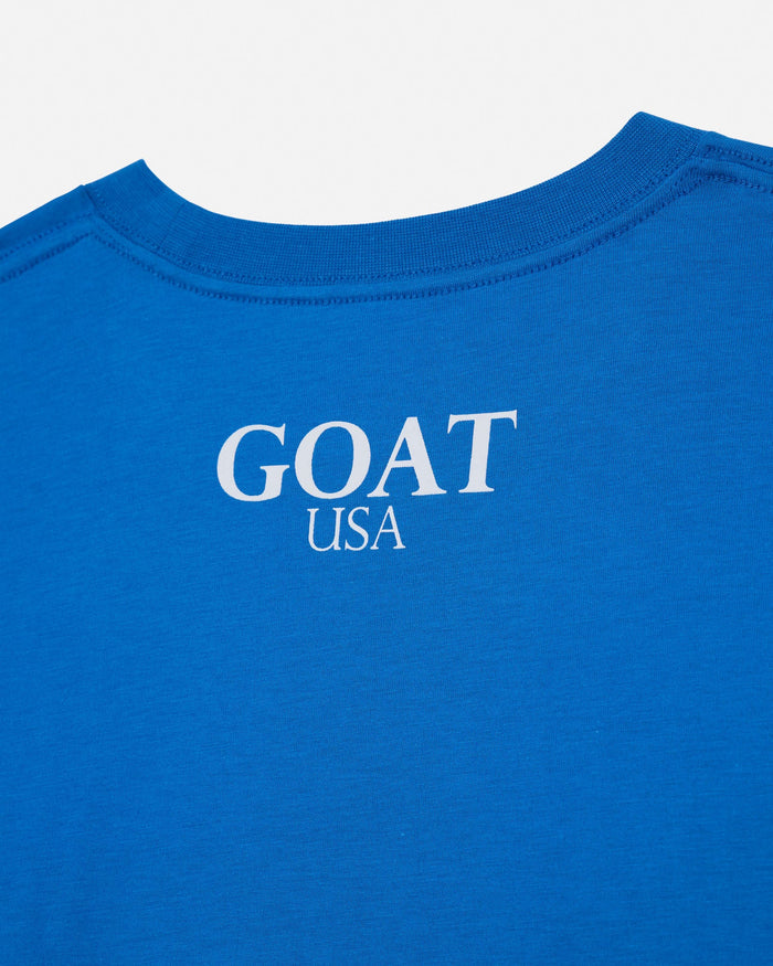 Close-up of the back of a bright blue t-shirt with 'GOAT USA' printed in white serif text on the center.#color_french-blue