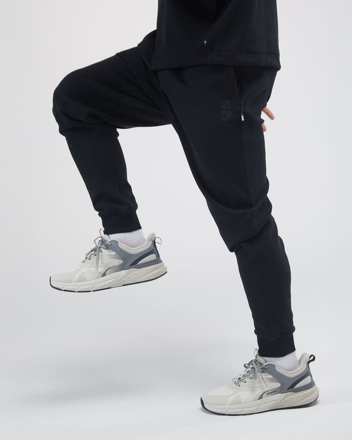 black performance joggers on model focused on legs#color_black