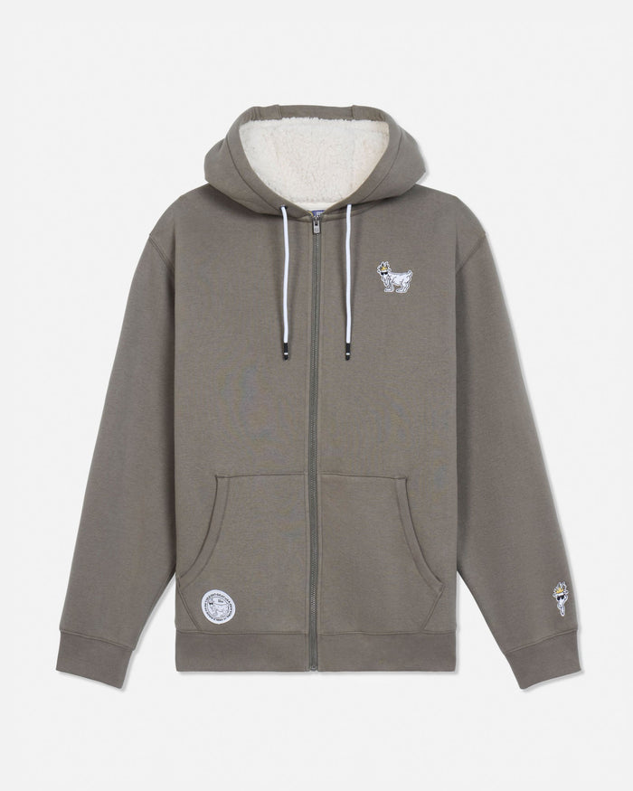 A taupe-brown full-zip hoodie with a cream sherpa-lined hood, featuring a small white graphic on the left chest, a circular patch on the lower left front pocket, and a small graphic on the right sleeve cuff.#color_smokey-olive