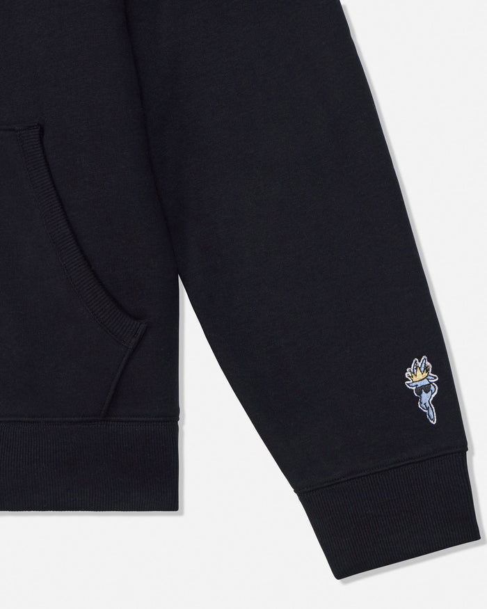 Close-up of a black sweatshirt sleeve with a ribbed cuff and pocket, featuring a small embroidered goat logo on the lower cuff.#color_black