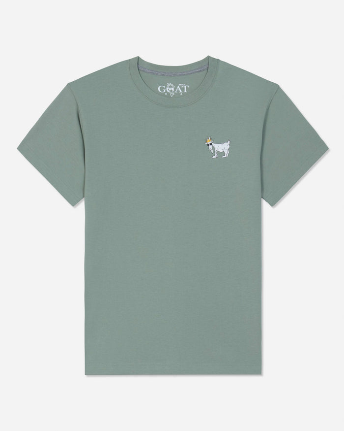 A sage green short-sleeve t-shirt with a small white embroidered goat logo on the left chest, displayed flat against a light gray background.#color_steeped-sage