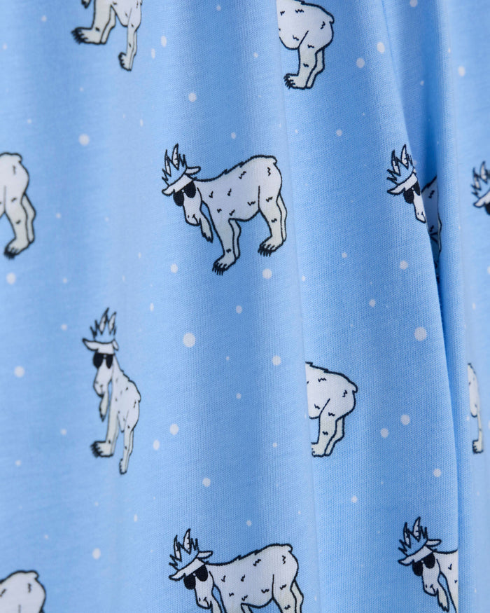 Pattern of cartoon-like animals on a blue background with white dots.