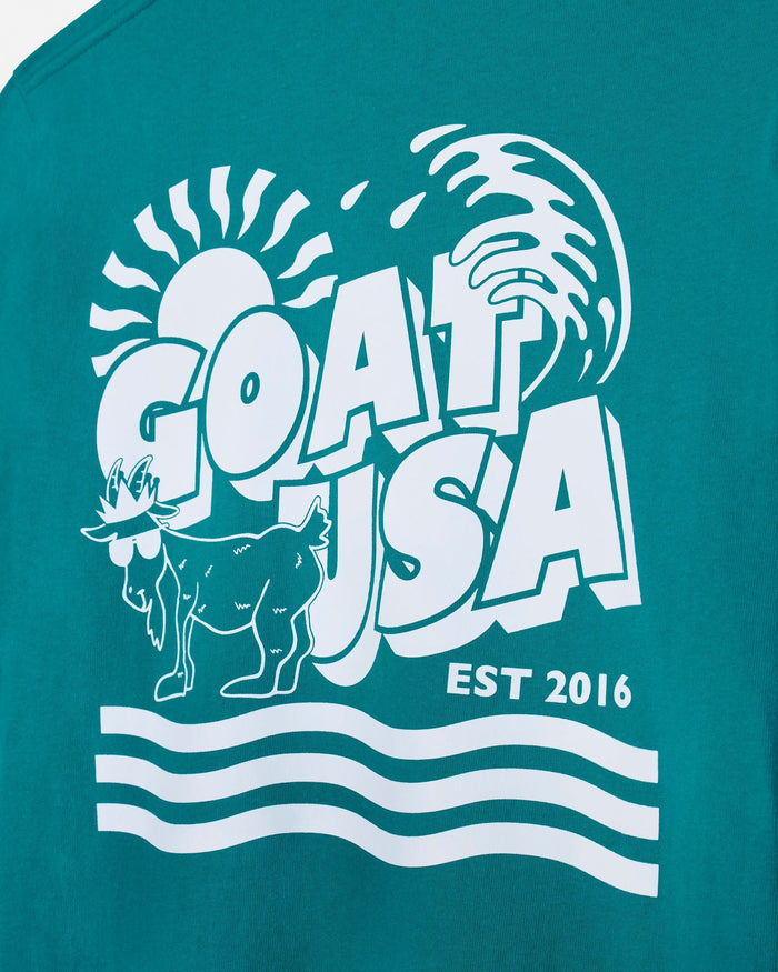 Teal t-shirt with white graphic design featuring a goat and 'GOAT USA' text