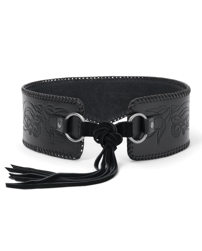 Introducing The Tooled Corset Belt in Black by THE GREAT. F26 STETSON—a striking wide leather belt featuring decorative stitching, embossed patterns reminiscent of tooled leather, two front metal rings, and a knotted suede tie with tassels for a distinctive western-inspired accent to any outfit.